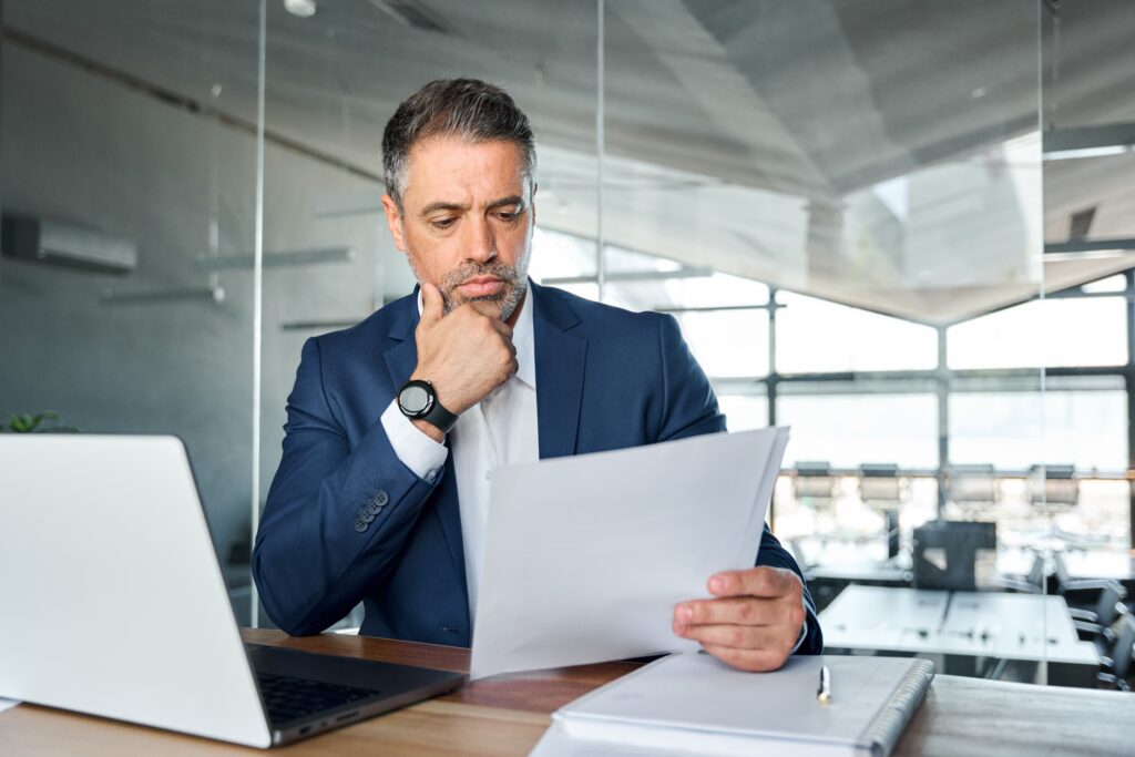 Business person reviewing risk management assessments